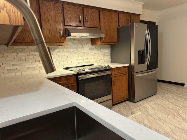 kitchen featuring ornamental molding, tasteful backsplash, and appliances with stainless steel finishes