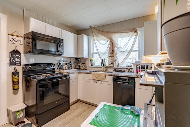 kitchen with white cabinetry, tasteful backsplash, and black appliances