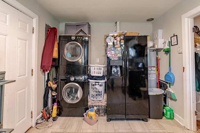 laundry room featuring stacked washer / drying machine, tile patterned flooring, and electric water heater