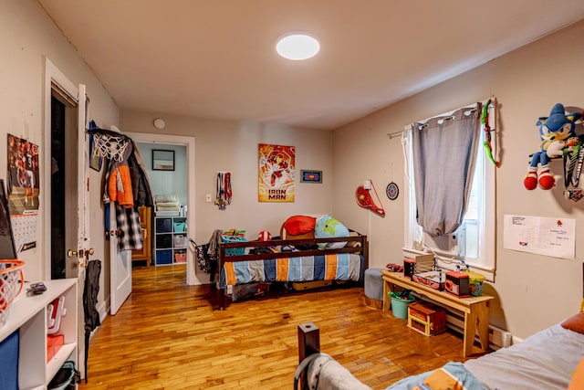 bedroom with wood-type flooring and cooling unit