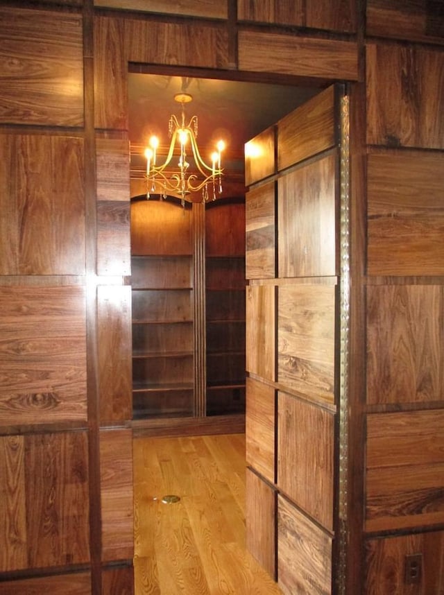 interior space with wood-type flooring and a chandelier