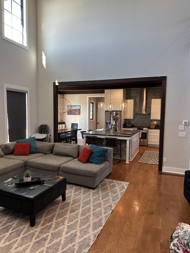 living room featuring hardwood / wood-style flooring and a high ceiling