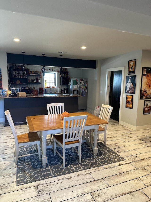 dining room with wood-type flooring