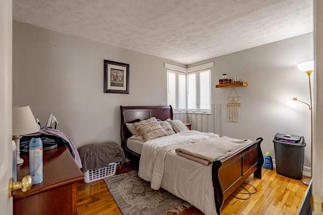 bedroom featuring a textured ceiling and hardwood / wood-style flooring