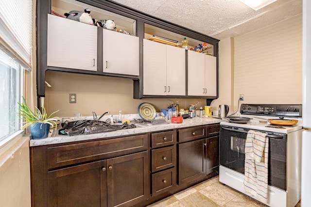 kitchen with white cabinets, white electric range, a textured ceiling, dark brown cabinets, and sink