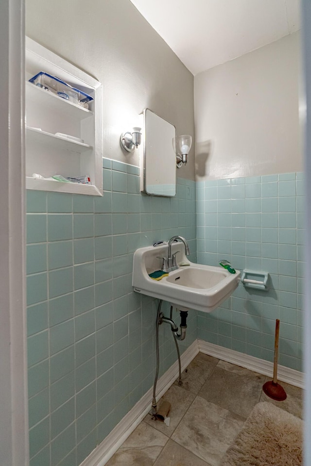 bathroom with tile walls, tile patterned flooring, and sink