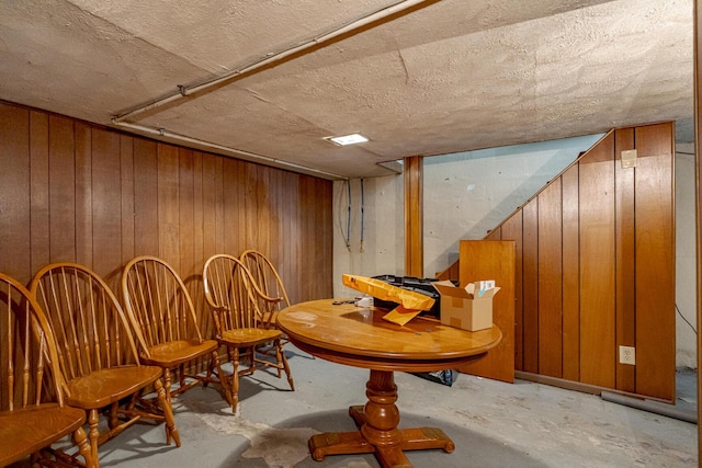 unfurnished room featuring wooden walls