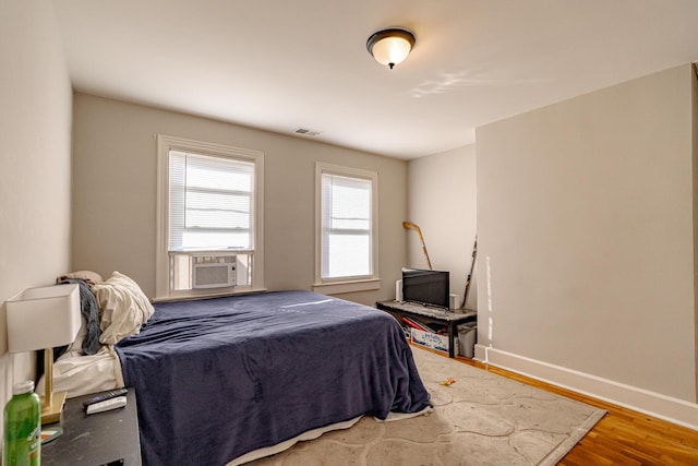 bedroom featuring cooling unit and wood-type flooring