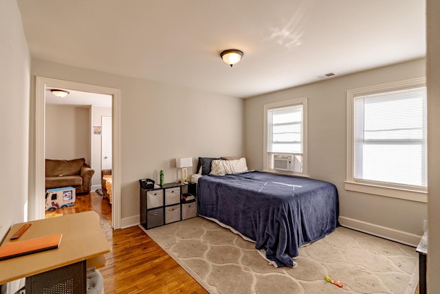 bedroom featuring cooling unit and wood-type flooring