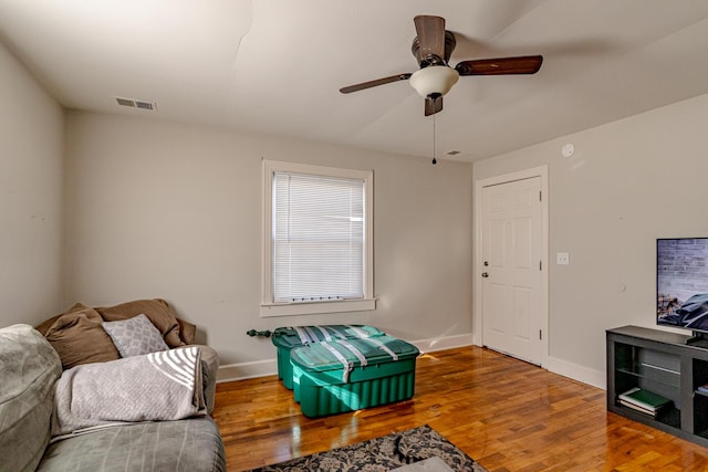 living room featuring ceiling fan and hardwood / wood-style flooring