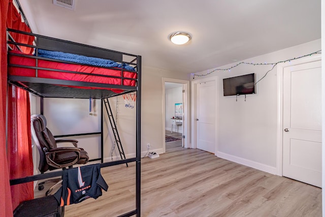 bedroom with wood-type flooring