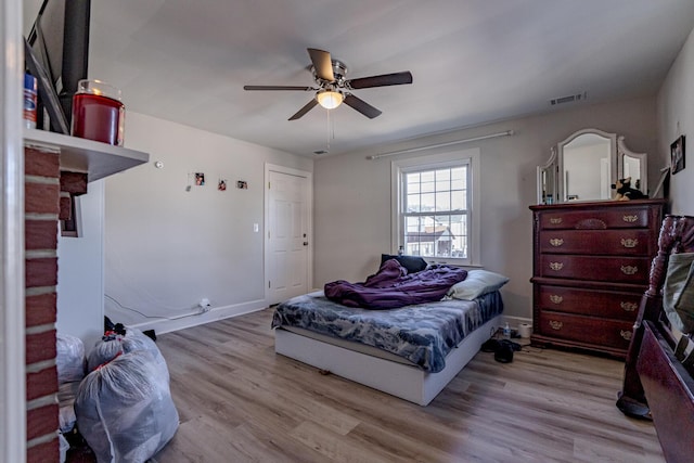 bedroom with ceiling fan and light hardwood / wood-style flooring