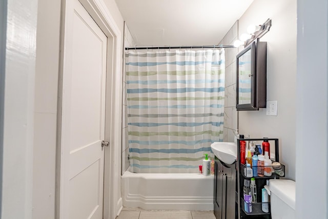 full bathroom with toilet, shower / bath combo with shower curtain, tile patterned floors, and vanity