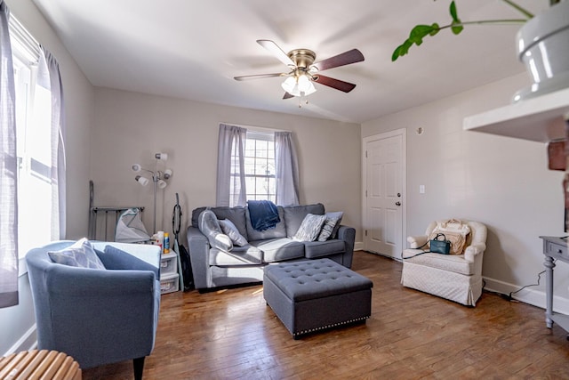 living room featuring dark hardwood / wood-style flooring and ceiling fan