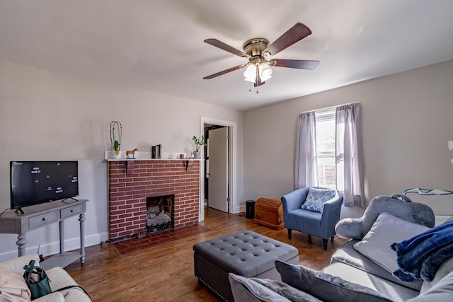 living room with ceiling fan, a fireplace, and hardwood / wood-style flooring