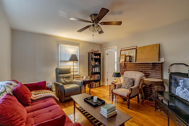 living room with ceiling fan and light hardwood / wood-style flooring