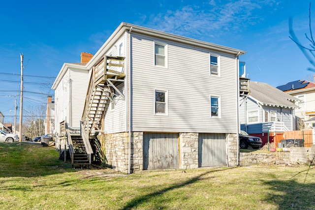 rear view of property featuring a lawn