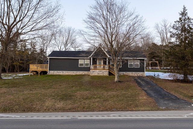 view of front of property with a front yard and a wooden deck