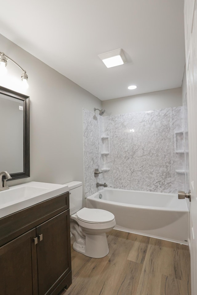 full bathroom with toilet, vanity, bathing tub / shower combination, and hardwood / wood-style floors