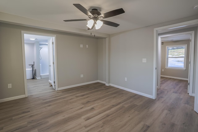 spare room featuring hardwood / wood-style flooring and ceiling fan