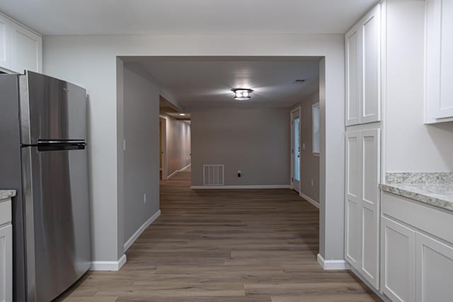 hallway with wood-type flooring