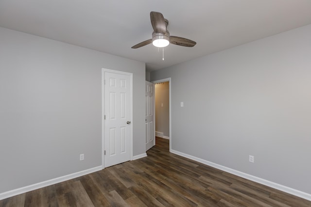 spare room with ceiling fan and dark hardwood / wood-style floors