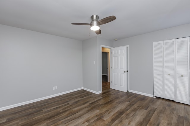 unfurnished bedroom with ceiling fan, dark hardwood / wood-style flooring, and a closet