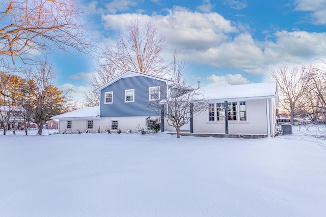 snow covered rear of property with central AC