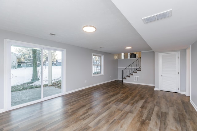 unfurnished living room featuring dark hardwood / wood-style flooring