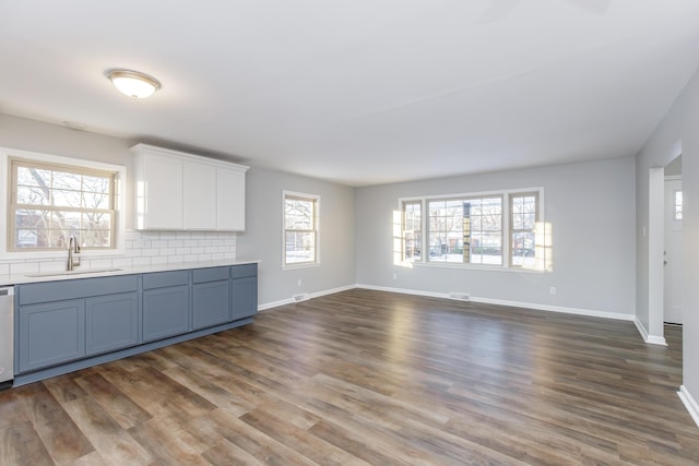 unfurnished living room with dark hardwood / wood-style floors and sink