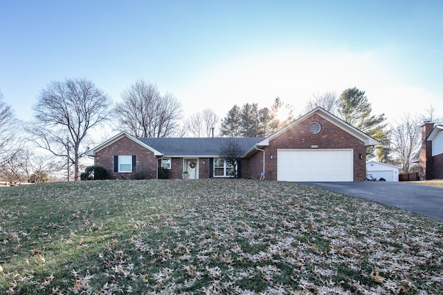 ranch-style house with a front yard and a garage