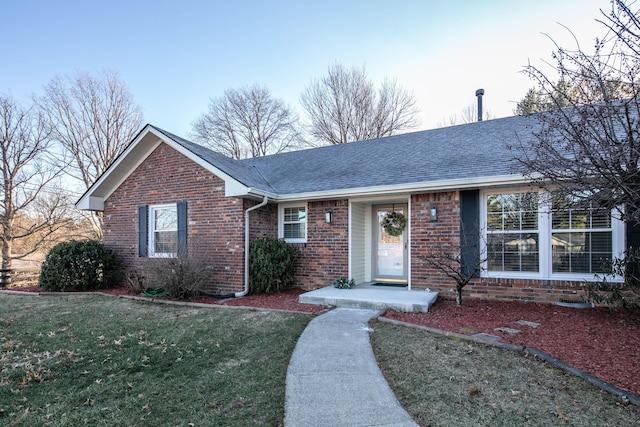 ranch-style home with a front lawn