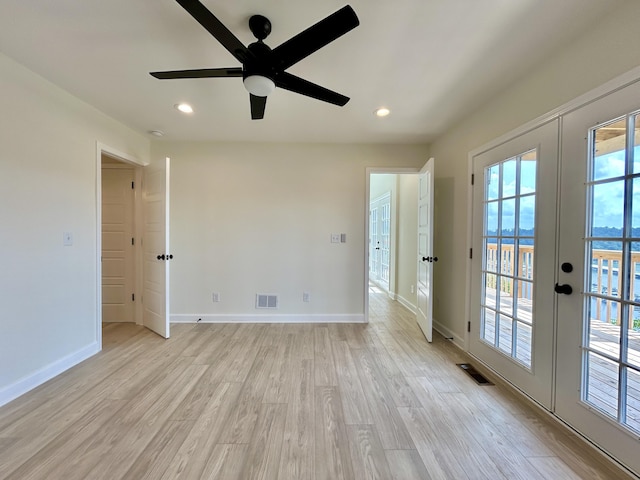 unfurnished room with french doors, light wood-type flooring, and ceiling fan