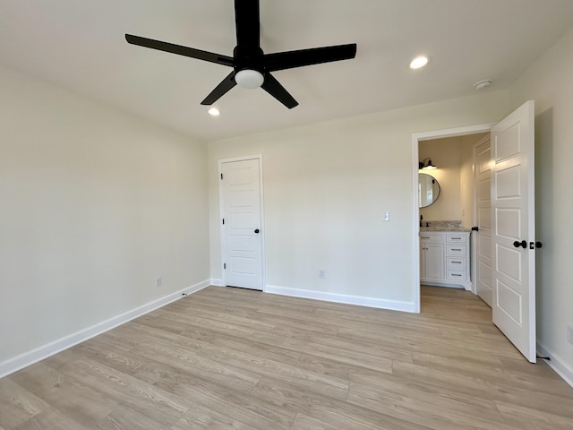 unfurnished bedroom featuring ceiling fan, light hardwood / wood-style floors, and ensuite bathroom