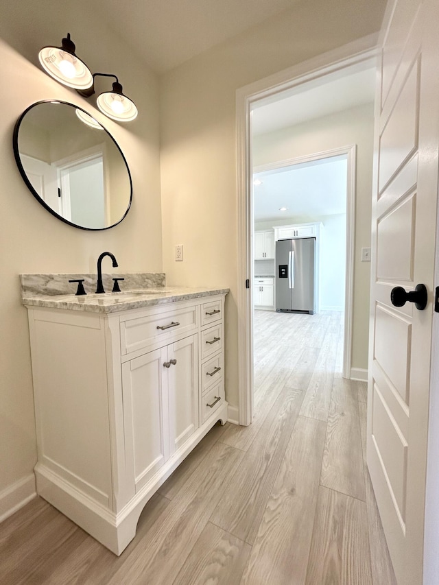 bathroom featuring hardwood / wood-style flooring and vanity