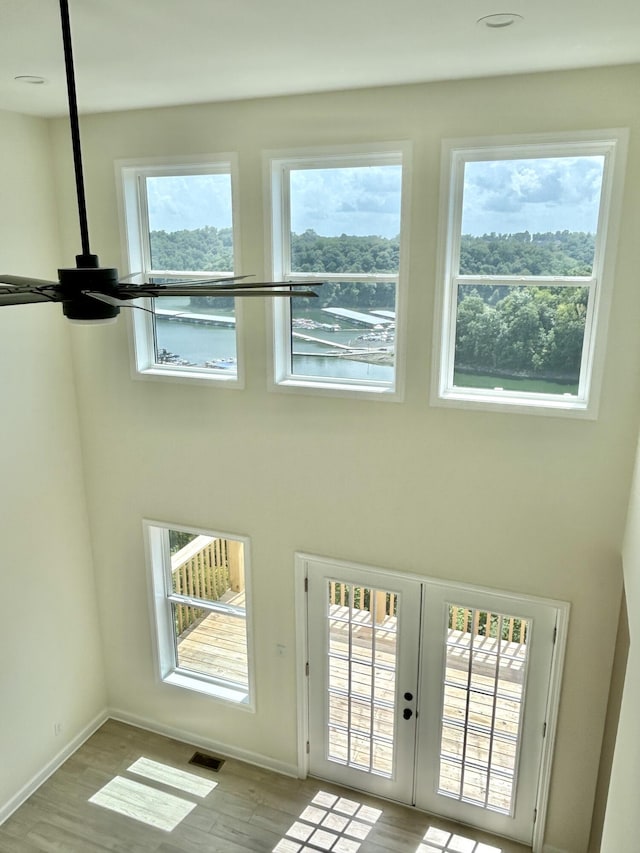 entryway featuring light wood-type flooring and french doors