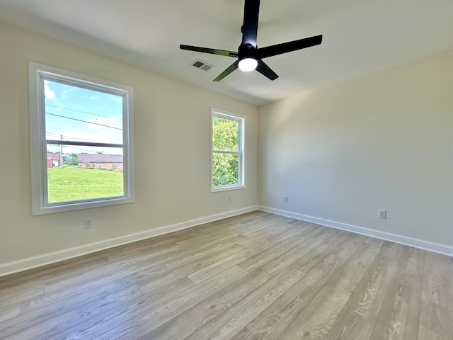 spare room with ceiling fan and light hardwood / wood-style flooring