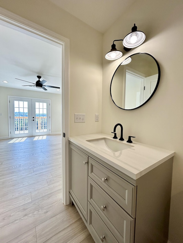 bathroom featuring ceiling fan, french doors, hardwood / wood-style floors, and vanity