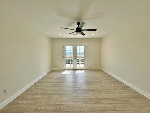 spare room with ceiling fan, french doors, and light hardwood / wood-style floors