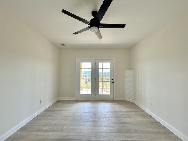 spare room featuring ceiling fan and light hardwood / wood-style flooring