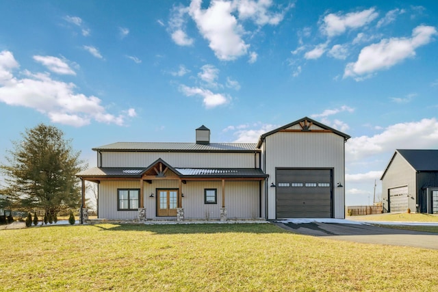 modern farmhouse featuring a front yard and a garage