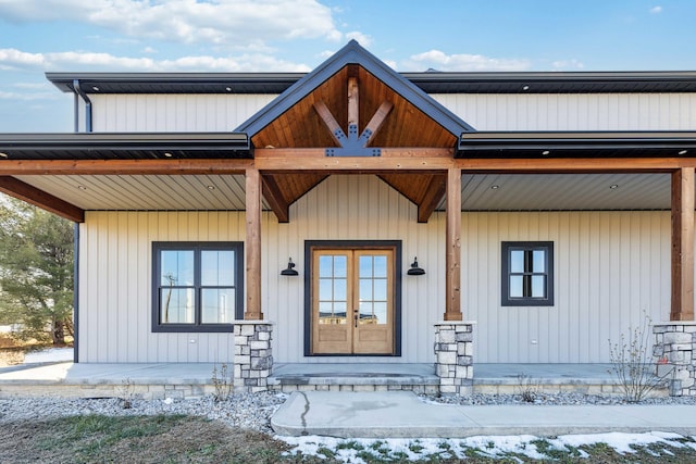 snow covered property entrance with a porch