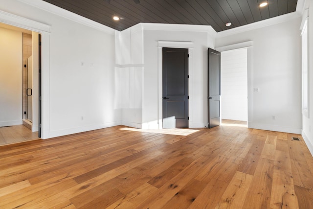 spare room featuring light hardwood / wood-style flooring, crown molding, and wood ceiling