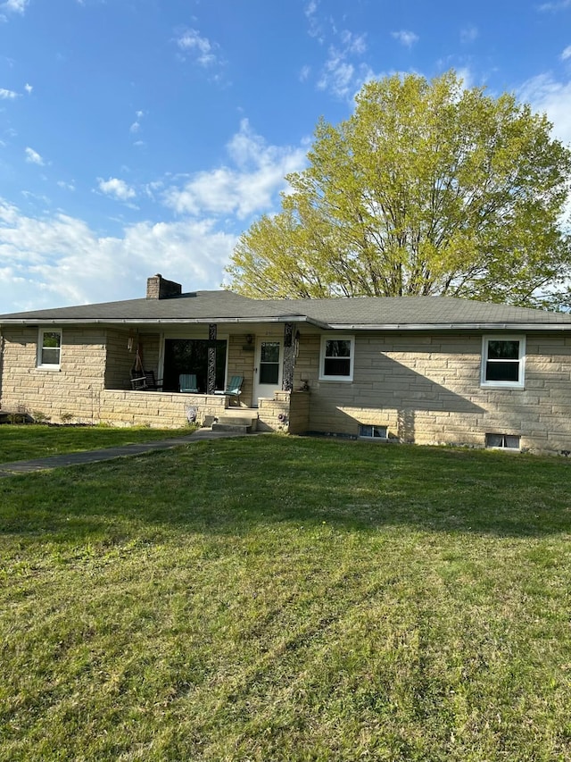 back of house featuring a lawn