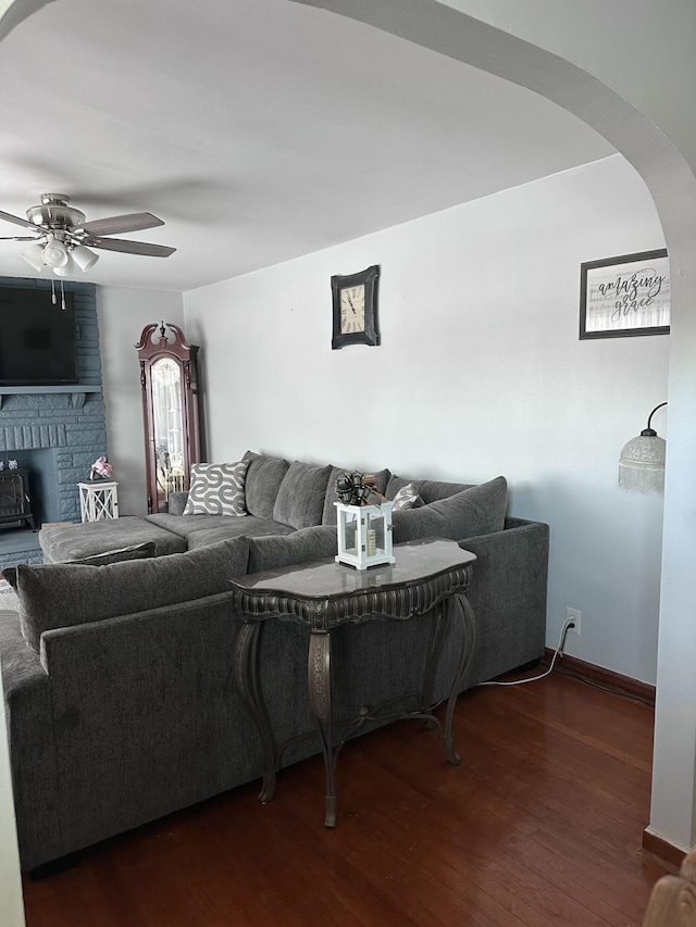 living room with ceiling fan and dark hardwood / wood-style floors