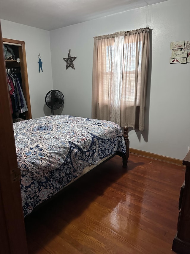 bedroom with wood-type flooring and a closet