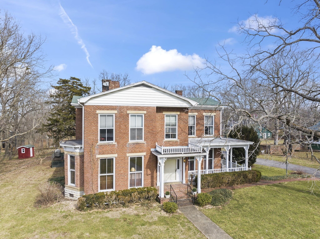 view of front of house with a porch and a front lawn