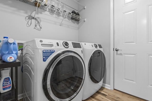 washroom featuring washing machine and dryer and light wood-type flooring