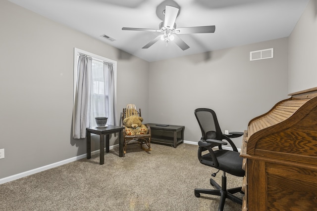 carpeted home office featuring ceiling fan