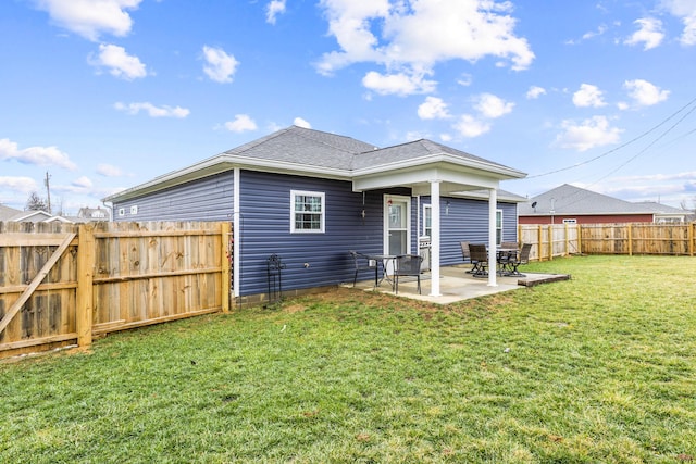 back of house featuring a yard and a patio area